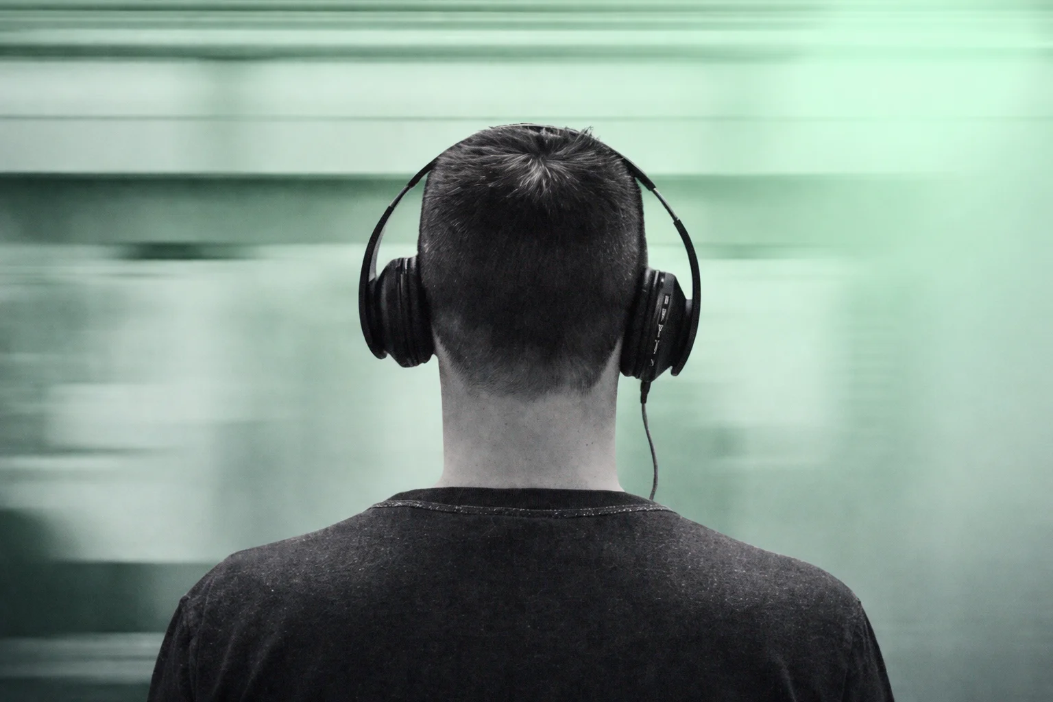 Audio description narrator recording voiceover in a professional studio booth